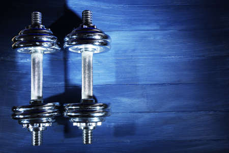 Dumbbells on color wooden backgroundの写真素材