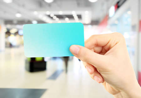 Hand holding blank card  on abstract backgroundの写真素材