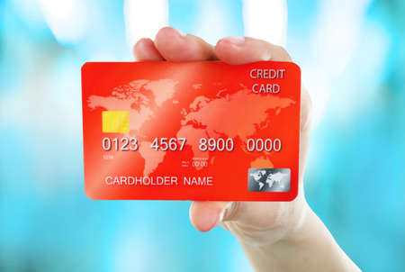 Hand holding credit card on abstract backgroundの写真素材
