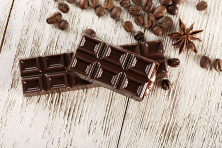 Stuffed chocolate with coffee beans and star anise on wooden table, top viewの写真素材