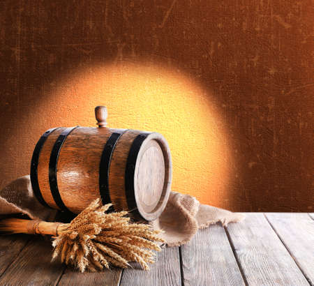 Beer barrel on table on brown backgroundの写真素材