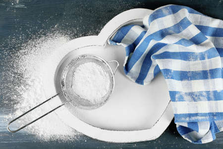 Sifting flour through sieve on wooden table, top viewの写真素材