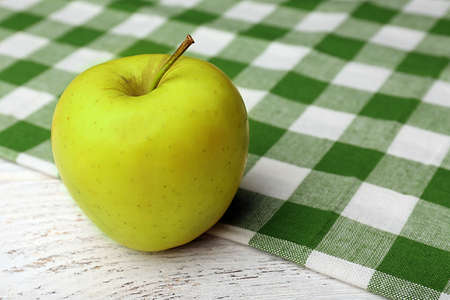 Apple with napkin on wooden table, closeupの写真素材