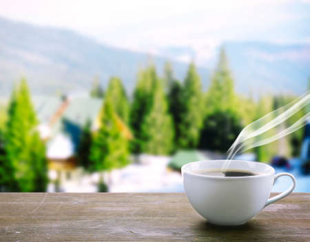 Cup of coffee on table on nature backgroundの写真素材