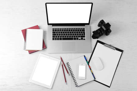 Office supplies and gadgets on white table, top viewの写真素材
