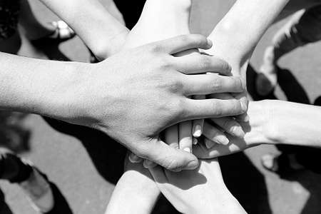United hands outdoors.  Black and white retro stylizationの写真素材