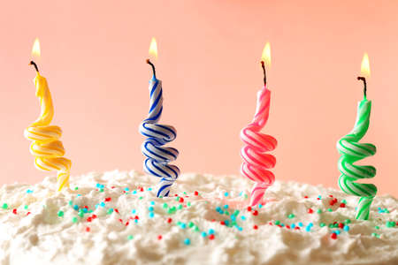 Birthday cake with candles on color backgroundの写真素材