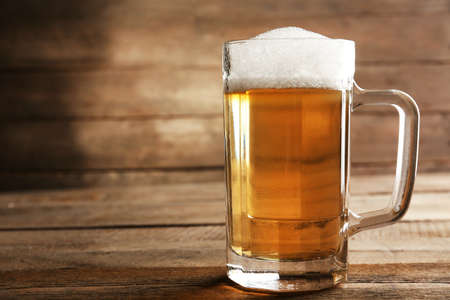 Glass of beer on wooden backgroundの写真素材