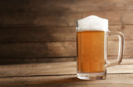 Glass of beer on wooden backgroundの写真素材