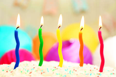 Birthday cake with candles on colorful backgroundの写真素材