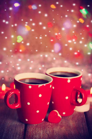 Two cups on table on bright lights backgroundの写真素材
