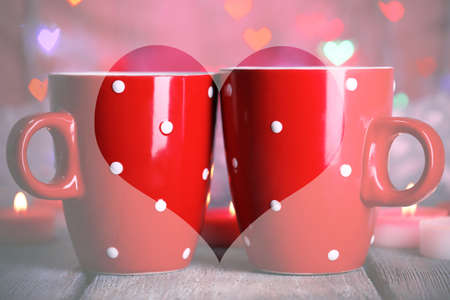 Two cups on table on bright lights backgroundの写真素材