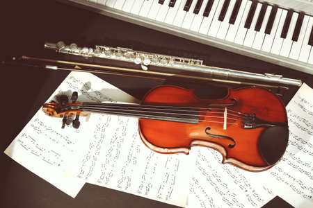 Musical instruments with music notes on dark backgroundの写真素材