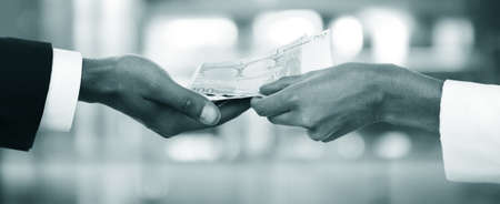 Woman hand takes money from the man's handの写真素材