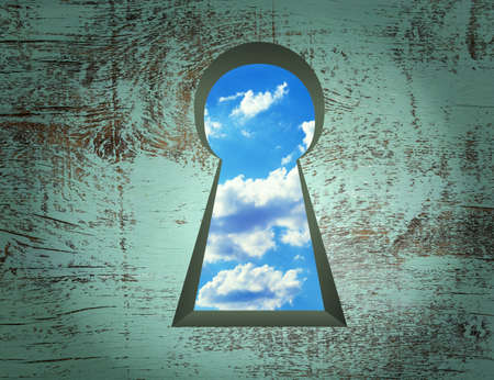 Keyhole on the wooden wall, the door to natureの写真素材