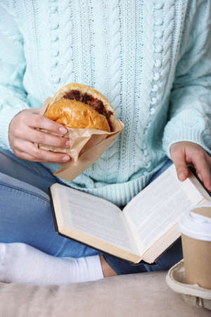 Woman with unhealthy fast food, close-upの写真素材