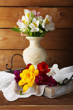 Beautiful spring flowers on wooden backgroundの写真素材