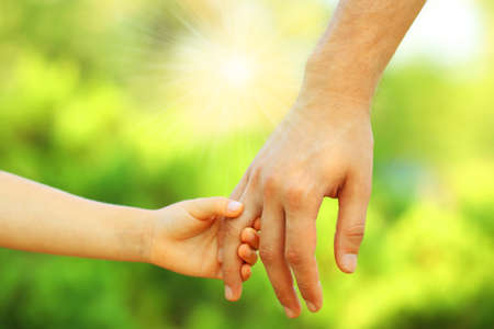 Hands of father and son holding each otherの写真素材