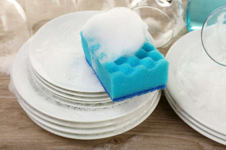 Dishes in foam with wisp on table close upの写真素材