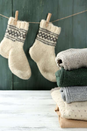 Knitting clothes on wooden backgroundの写真素材