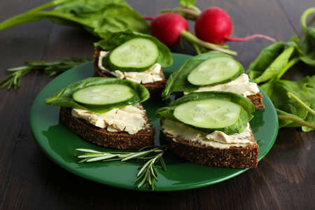 Delicious sandwiches with vegetables and greens on plate close upの写真素材