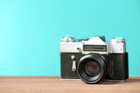 Retro camera on table on green backgroundの写真素材
