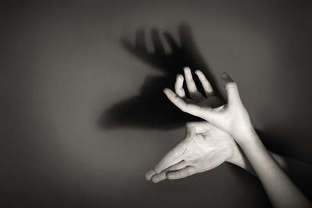 Hands gesture like deer on gray backgroundの写真素材