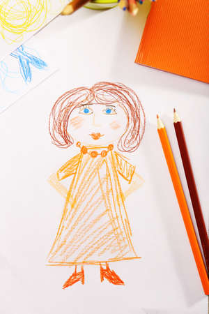 Kids drawing on white sheet of paper with crayons, closeupの写真素材