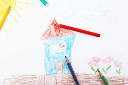 Kids drawing on white sheet of paper with crayons, closeupの写真素材
