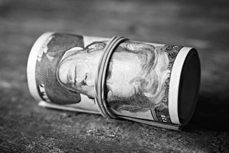 Dollars roll on wooden backgroundの写真素材