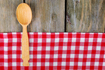 Checkered napkin with spoon on wooden table backgroundの写真素材