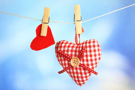Hearts hanging on rope on bright backgroundの写真素材