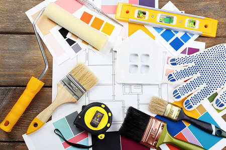 Construction instruments, plan and brushes on wooden table backgroundの写真素材