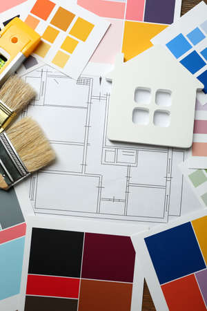 Construction instruments, plan and brushes on wooden table backgroundの写真素材