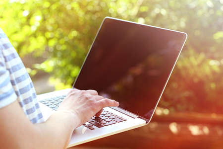 Young man working with laptop in parkの写真素材