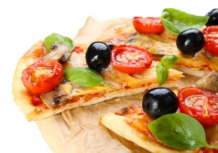 Tasty pizza with vegetables and basil on cutting board close upの写真素材
