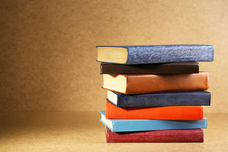Old books on shelf, close-up, on wooden backgroundの写真素材