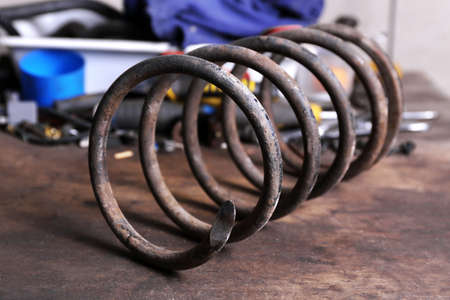 Large metal spring on workplace in garageの写真素材