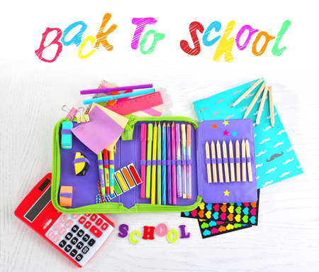 Pencil case with various stationery on wooden tableの写真素材