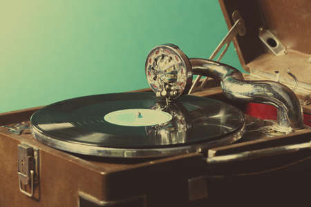 Gramophone with vinyl record on table on wall backgroundの写真素材