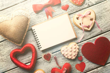 Blank page with cakes and decorative hearts on blue wooden backgroundの写真素材