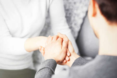 Man and woman holding hands closeupの写真素材