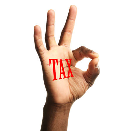 Tax concept. Man's hand with Tax sign, isolated on whiteの写真素材