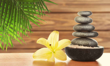 Composition with spa stones and lily on wooden backgroundの写真素材