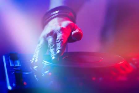 DJ playing music at mixer closeupの写真素材
