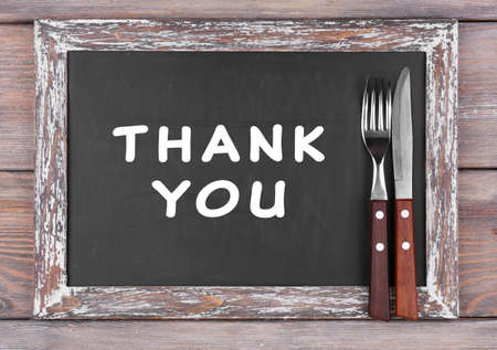 Blackboard menu with text Thank You on rustic wooden planks backgroundの写真素材
