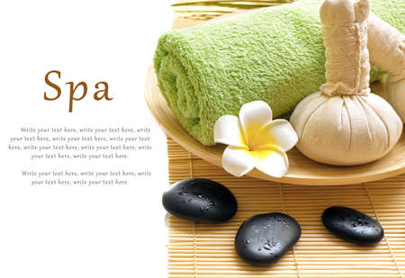 Beautiful spa composition. Herbal balls and towel in the bowl. Pebbles and cosmetics close upの写真素材