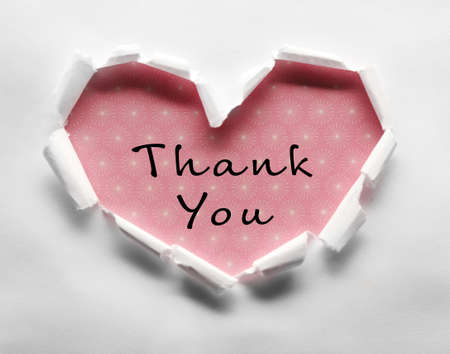 Torn paper heart and text Thank You over colorful backgroundの写真素材