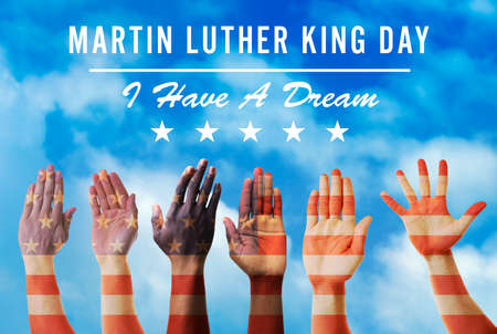 Martin Luther King Day. Different hands on blue sky background