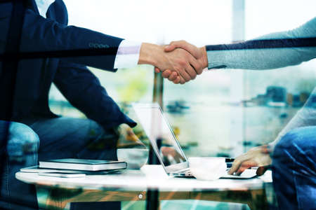 Business handshake on blurred International Airport Terminal backgroundの写真素材